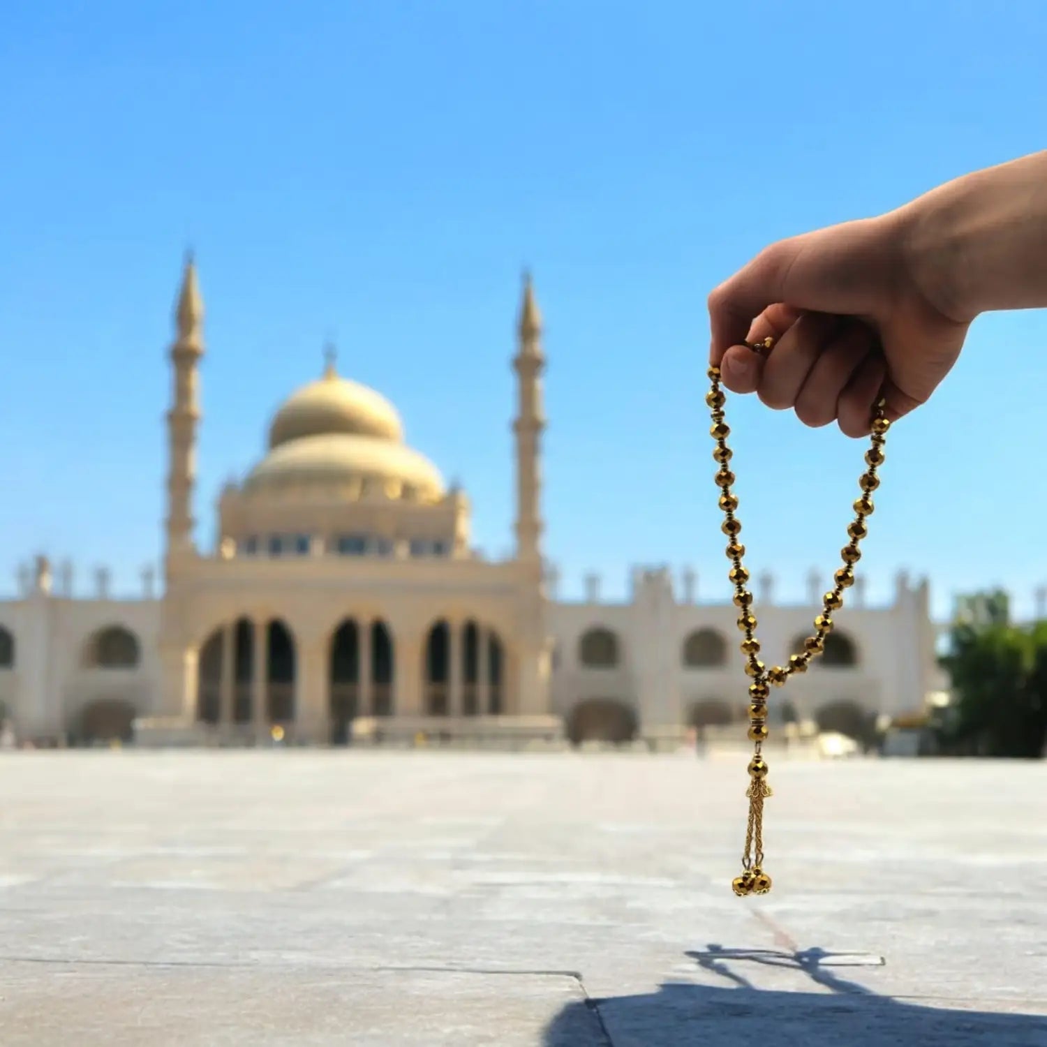 Golden prayer beads displayed with Crystal Tasbeeh 33 pack of 12 for spiritual practice