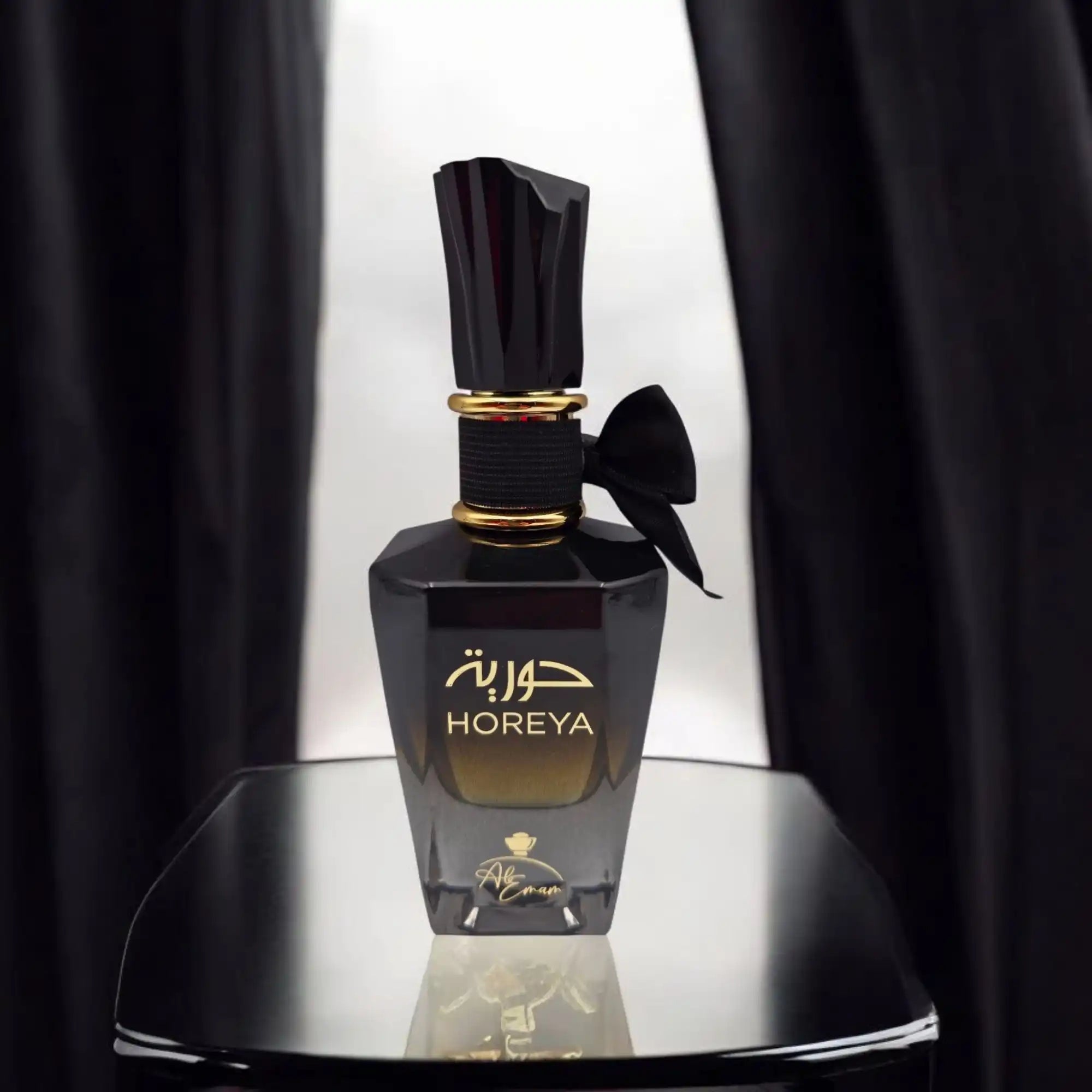 Elegant black perfume bottle with gold accents.